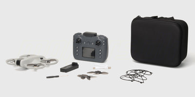 Drone M6 Zoomer ligger beskyttet i sin originale emballage med fjernbetjening og tilbehør synligt.