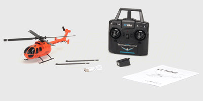 Orange C186 fjernstyret helikopter i orange og hvidt design vist fra siden på en hvid baggrund.