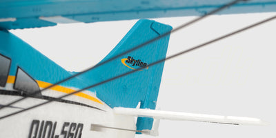Hvidt og blåt Qidi-560 Brushless sportsfly med rød propel set fra siden på hvid baggrund.