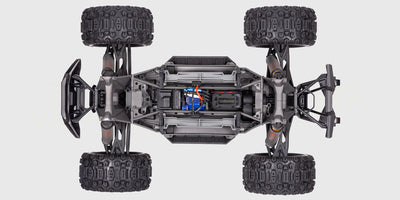 Traxxas X-Maxx 8S fjernstyret monster truck med orange karosseri og grove offroad-dæk set fra siden.